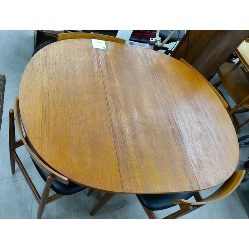 212 - A G-Plan teak drop-leaf table, raised on turned legs  29