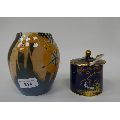 214 - A Carltonware china sugar pot with a cover and spoon, decorated in a version of the Mikado pattern, ... 