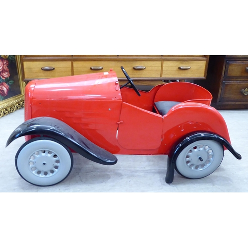 217 - A mid 20thC vintage pedal car, in red livery and black trim