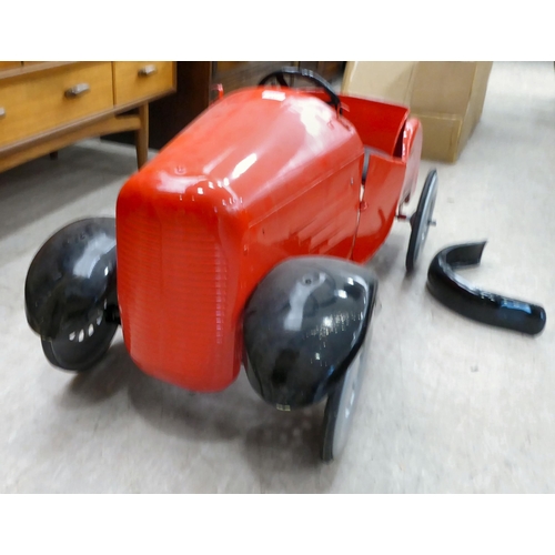 217 - A mid 20thC vintage pedal car, in red livery and black trim