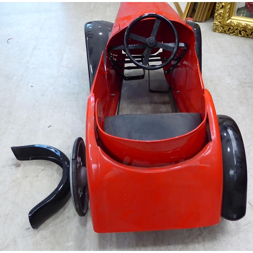 217 - A mid 20thC vintage pedal car, in red livery and black trim