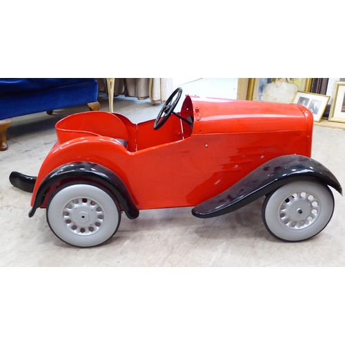 217 - A mid 20thC vintage pedal car, in red livery and black trim