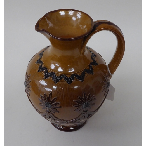 219 - A late Victorian Doulton Lambeth stoneware ovoid shape jug with a narrow neck and strap handle, unif... 