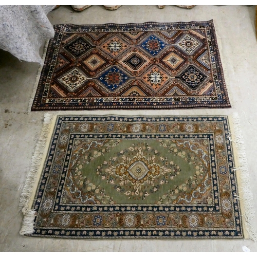 230 - Two similar rugs, decorated with repeating designs, on multi-coloured grounds  34