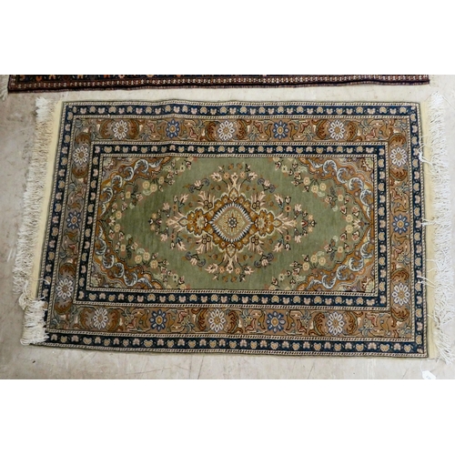 230 - Two similar rugs, decorated with repeating designs, on multi-coloured grounds  34