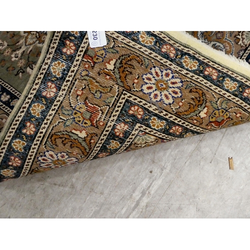 230 - Two similar rugs, decorated with repeating designs, on multi-coloured grounds  34