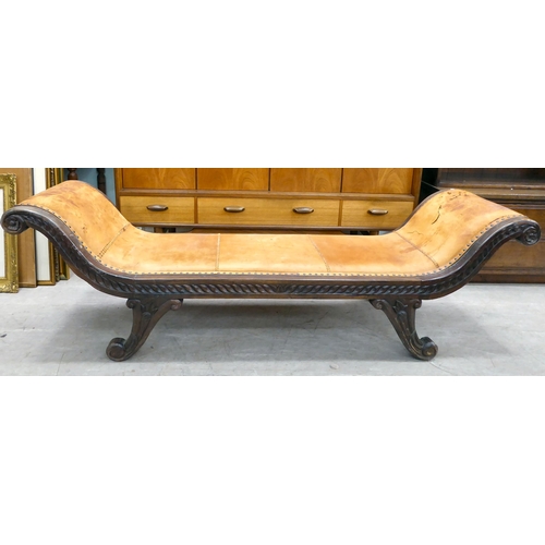 237 - A 20thC Asian hardwood framed window seat, stud upholstered in tan coloured hide, raised on splayed ... 