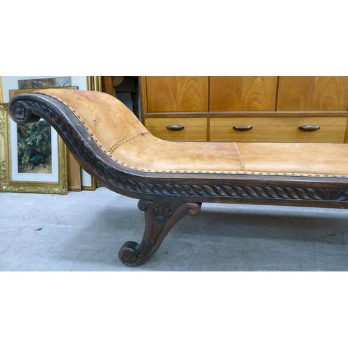 237 - A 20thC Asian hardwood framed window seat, stud upholstered in tan coloured hide, raised on splayed ... 