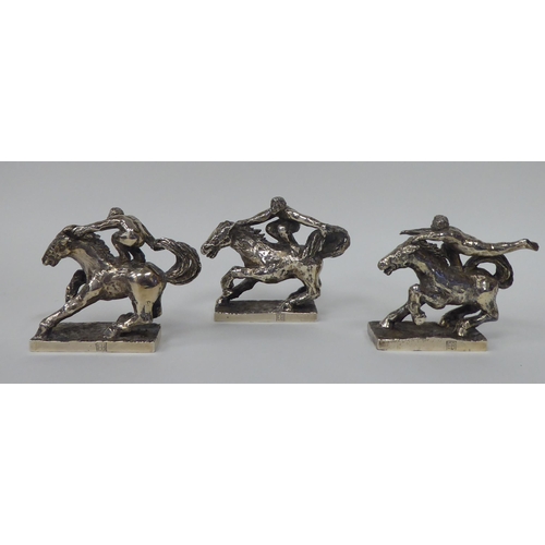 256 - A series of three, solid silver models, depicting acrobatic horsemen, each set on a rectangular plin... 