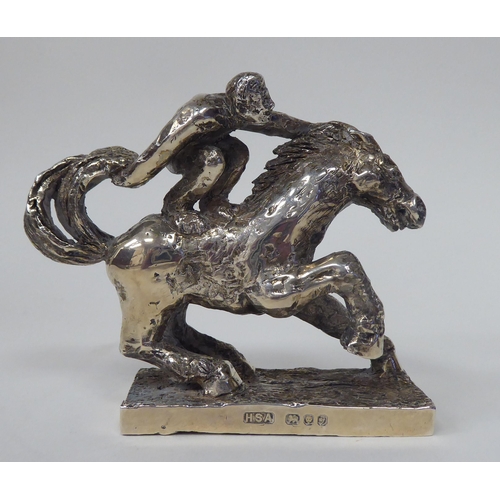 256 - A series of three, solid silver models, depicting acrobatic horsemen, each set on a rectangular plin... 