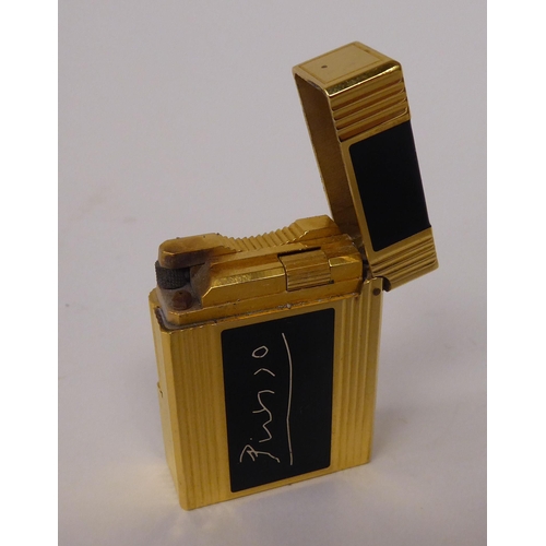 260 - A Dupont Picasso Faune edition, gold plated and black enamel, gas filled cigarette lighter, dated 15... 