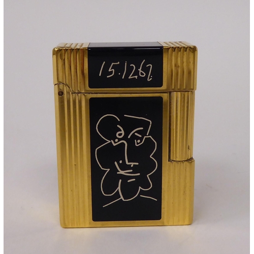 260 - A Dupont Picasso Faune edition, gold plated and black enamel, gas filled cigarette lighter, dated 15... 