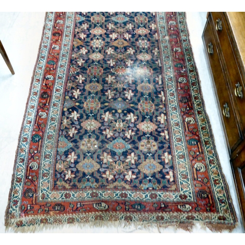 266 - An antique Persian runner, decorated with repeating floral designs, on a multi-coloured ground ... 