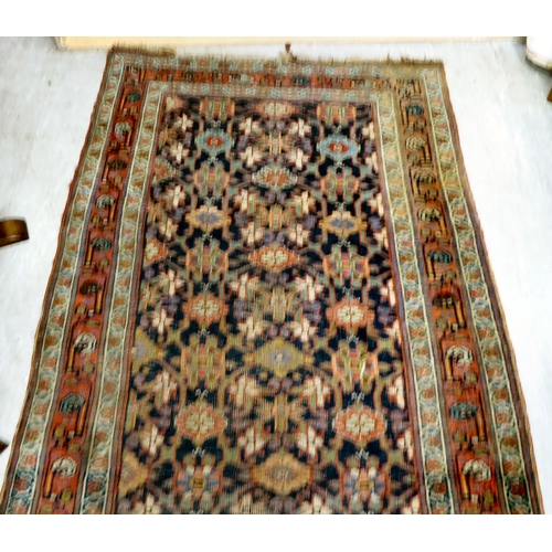 266 - An antique Persian runner, decorated with repeating floral designs, on a multi-coloured ground ... 