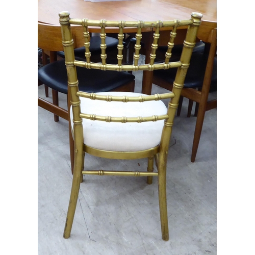 269 - A gilt sprayed, bamboo effect bedroom chair with a mushroom coloured upholstered seat