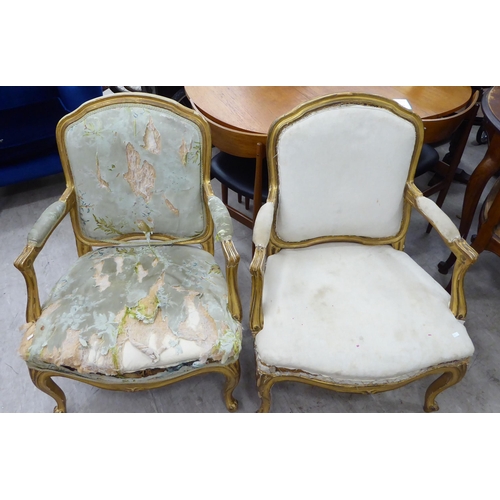 270 - A pair of late 19thC French gilded pine, showwood framed, open arm salon chairs, raised on cabriole ... 