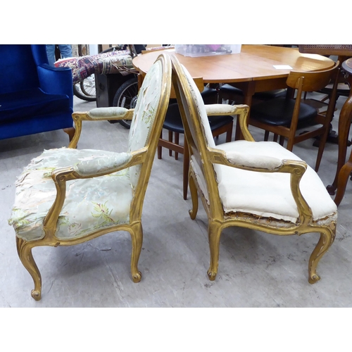 270 - A pair of late 19thC French gilded pine, showwood framed, open arm salon chairs, raised on cabriole ... 