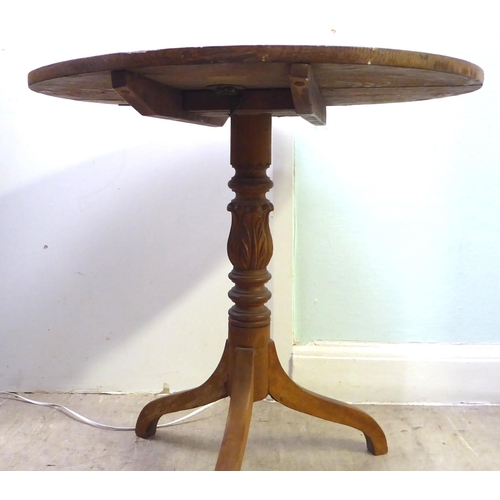 271 - A late 19thC oak pedestal tip-top table, raised on a tripod base  29