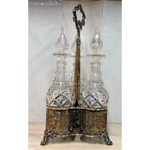 282 - An ornate cast silver plated cruet stand, hosting three glass decanters with stoppers