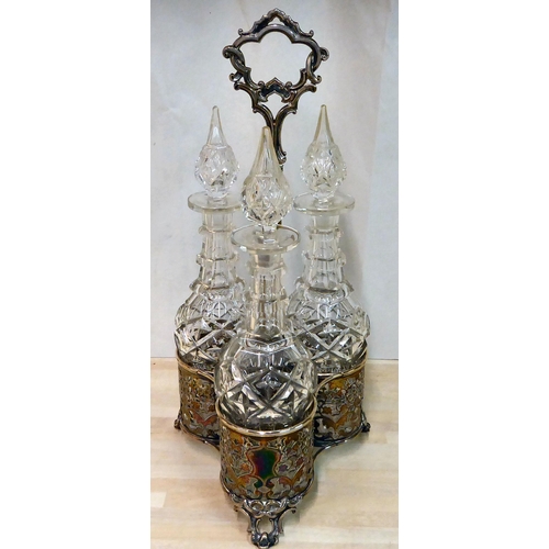 282 - An ornate cast silver plated cruet stand, hosting three glass decanters with stoppers