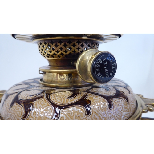 33 - A Royal Doulton two-part stoneware and brass table oil lamp, on a black glass pedestal base, decorat... 