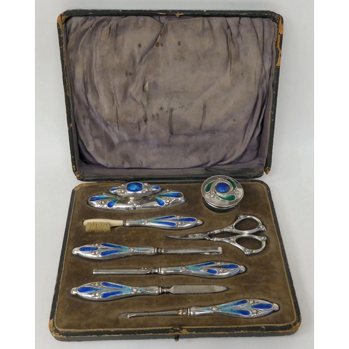 366 - An Art Nouveau silver and enamel, eight piece manicure set, in a fitted case  Birmingham 1910