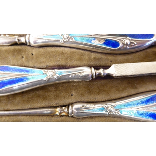 366 - An Art Nouveau silver and enamel, eight piece manicure set, in a fitted case  Birmingham 1910