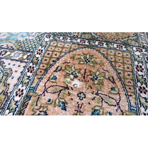 38 - A Persian part silk woven rug, decorated with pictorial boxes, on a multi-coloured ground and tassel... 