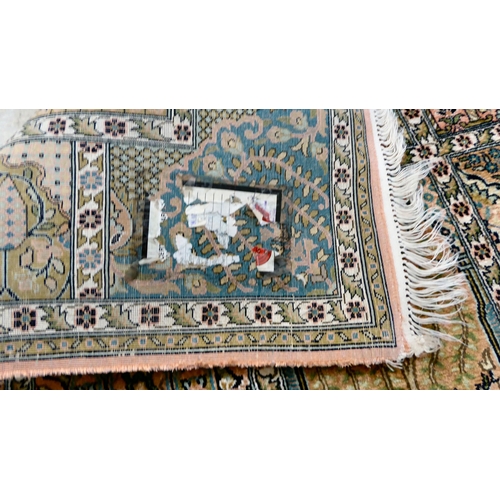 38 - A Persian part silk woven rug, decorated with pictorial boxes, on a multi-coloured ground and tassel... 