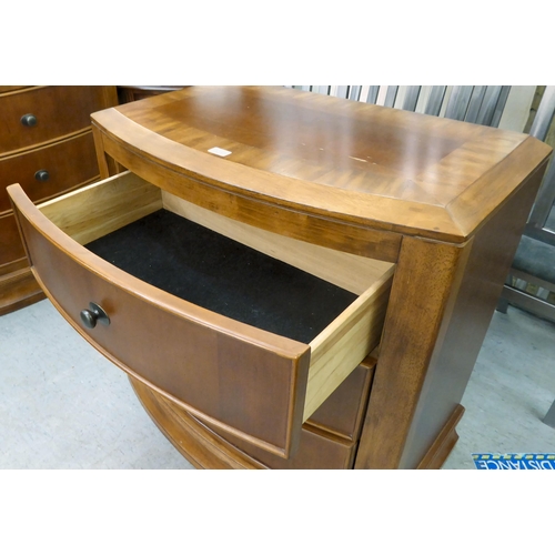 405 - A modern mahogany finished bowfront, three drawer dressing chest, on a plinth  32