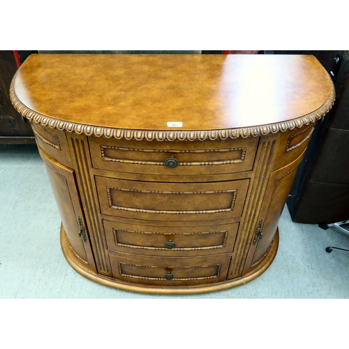 407 - A modern walnut finished bowfront sideboard with four drawers/two doors, on a plinth  32