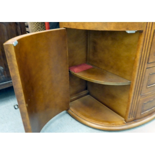 407 - A modern walnut finished bowfront sideboard with four drawers/two doors, on a plinth  32