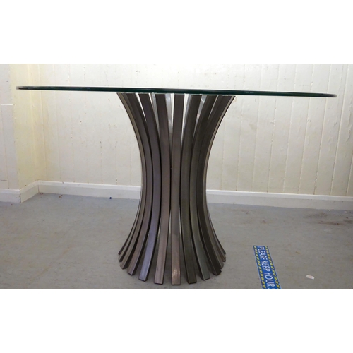 411 - A modern breakfast table with a glass top and a crushed metal, slatted base  30