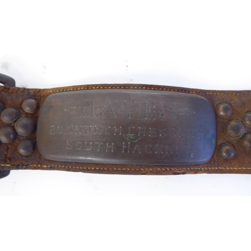 45 - A late 19th/early 20thC stitched brown hide, buckled dog collar with decorative studwork and a brass... 