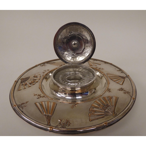 5 - A late Victorian Elkington & Co silver plated inkwell, the cut glass reservoir set in a saucer b... 