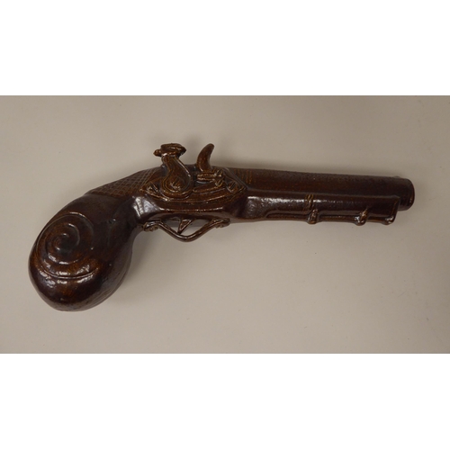 51 - A late 19thC treacle glazed novelty bottle, fashioned as a flintlock pistol  9