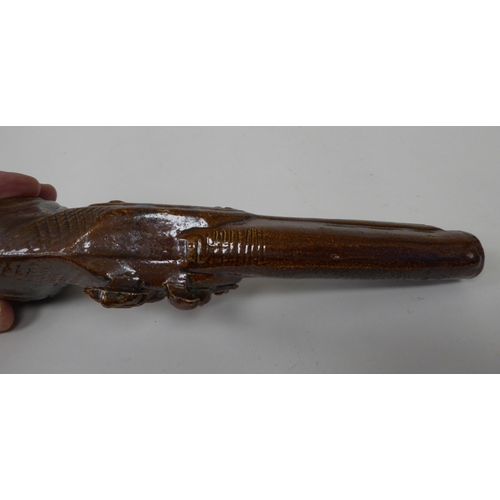 51 - A late 19thC treacle glazed novelty bottle, fashioned as a flintlock pistol  9