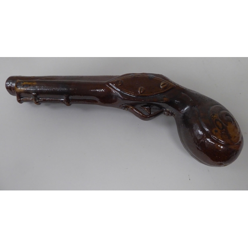 51 - A late 19thC treacle glazed novelty bottle, fashioned as a flintlock pistol  9