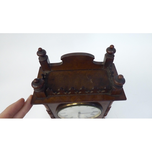 53 - A late 19thC walnut veneered cased mantel timepiece with turned, flank pilasters and a fretworked ga... 