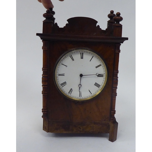 53 - A late 19thC walnut veneered cased mantel timepiece with turned, flank pilasters and a fretworked ga... 