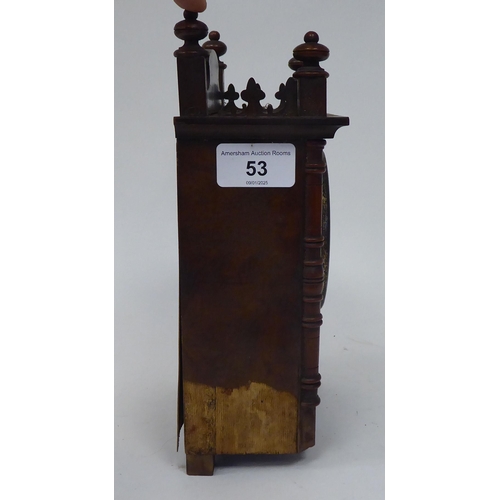 53 - A late 19thC walnut veneered cased mantel timepiece with turned, flank pilasters and a fretworked ga... 