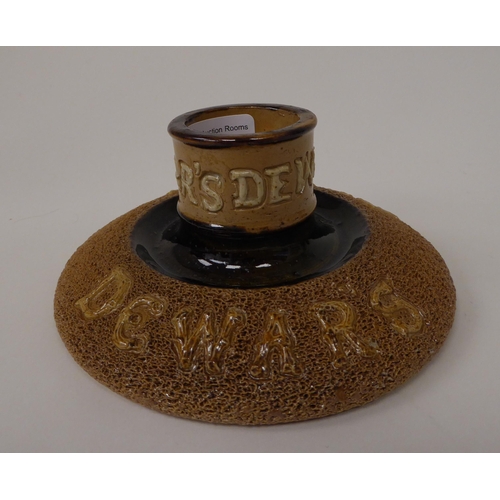 54 - A Royal Doulton textured brown stoneware vesta holder, commissioned by Dewar's  bears an impres... 