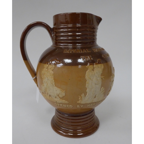 6 - A late 19thC two tone brown stoneware jug of bulbous form with a ribbed neck and pedestal foot, deco... 