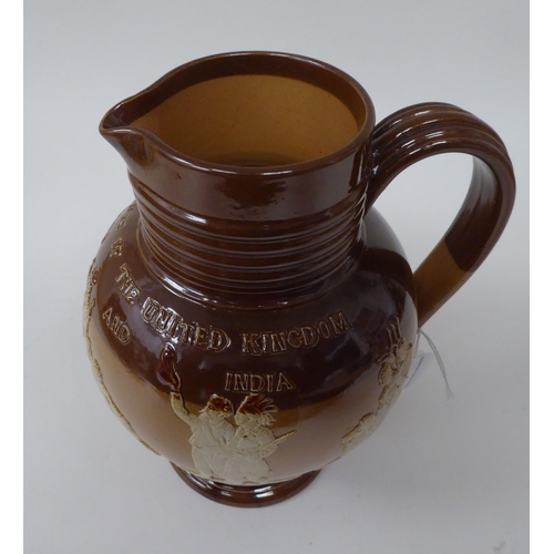 6 - A late 19thC two tone brown stoneware jug of bulbous form with a ribbed neck and pedestal foot, deco... 