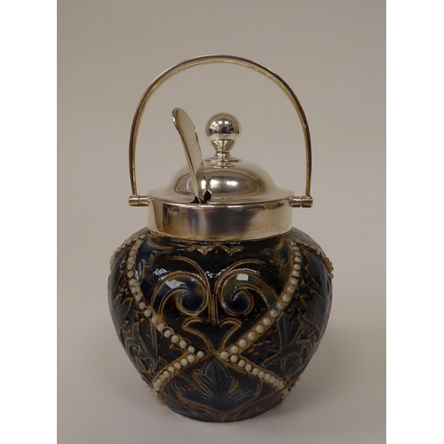 64 - A Doulton Lambeth stoneware conserve pot of bulbous form with a silver plated collar, swing handle, ... 