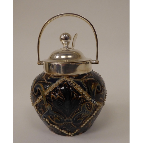 64 - A Doulton Lambeth stoneware conserve pot of bulbous form with a silver plated collar, swing handle, ... 