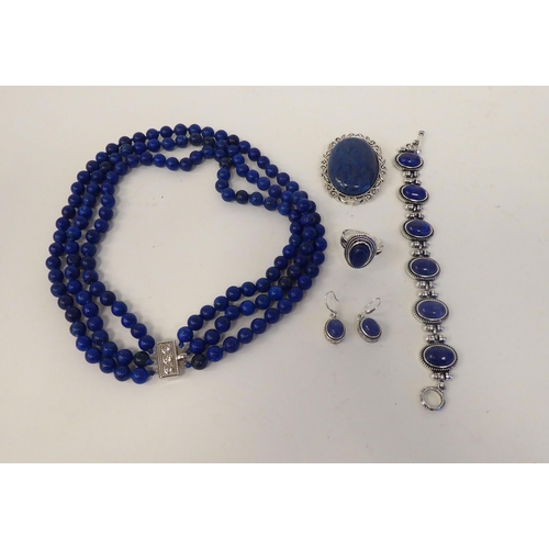 65 - A modern lapis lazuli coloured suite of jewellery, viz. a triple row necklace, a bracelet, ring and ... 