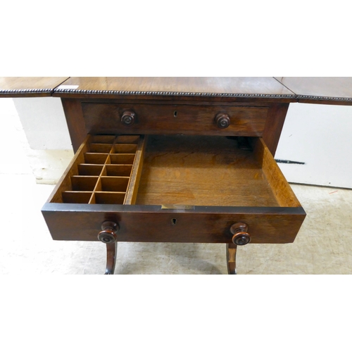 66 - A Regency rosewood combination writing/sewing table with two drawers, over a deep fabric covered dra... 