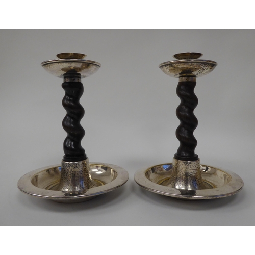 67 - A pair of early 20thC silver plated candlesticks with barleytwist oak stems, spot hammered sconces a... 