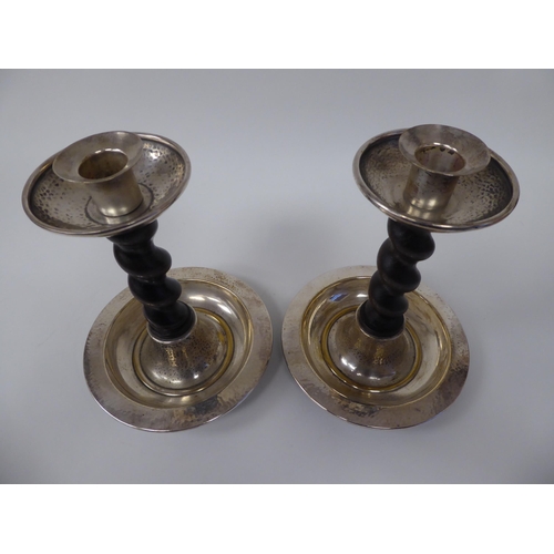 67 - A pair of early 20thC silver plated candlesticks with barleytwist oak stems, spot hammered sconces a... 